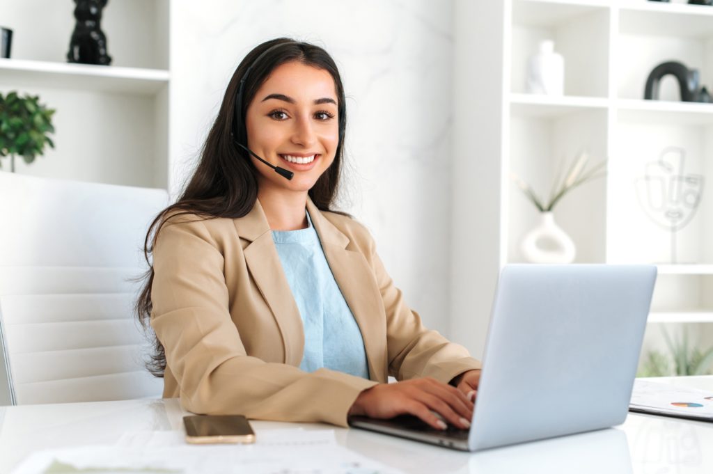 Call center, customer support service. Confident positive woman, call center operator with headset